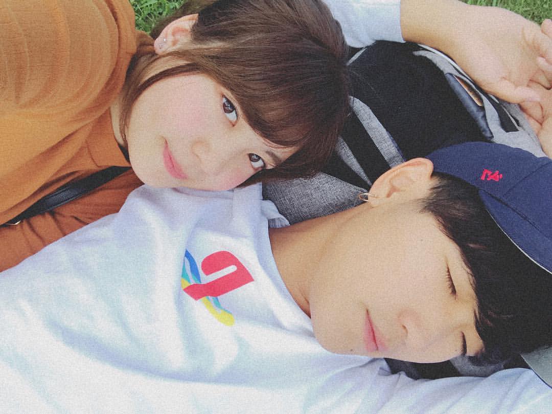 ベッドから出るのが快適すぎる朝の時間帯にベッドでお互いの腕の中で寝ているリラックスした若いカップルのショットPremium写真